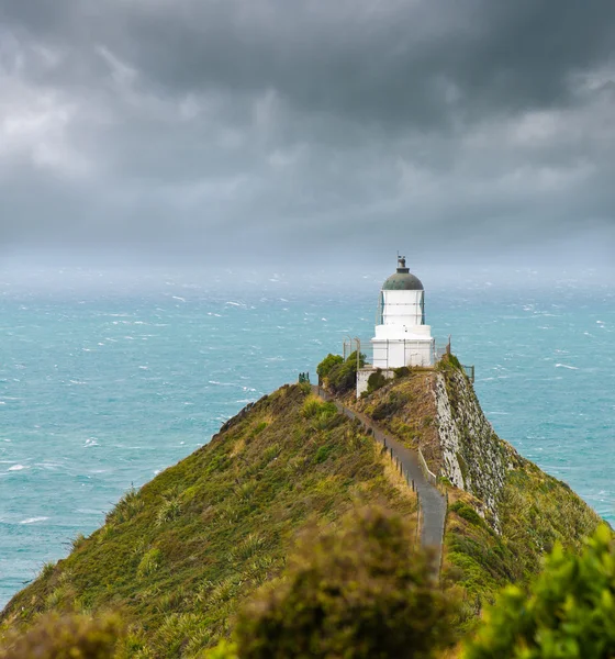 Nugget Point Light House and dark clouds in the sky — Stock Photo, Image