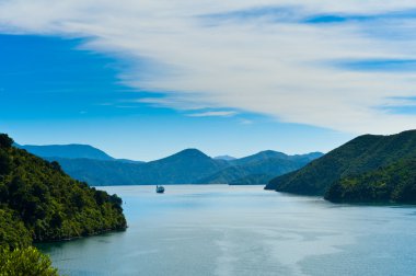 Incoming Ferry through a fjord clipart