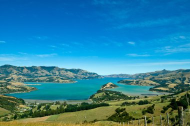 Beautiful summer day view into the Akaroa Harbour clipart