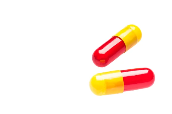 Two Bicolor capsules over white — Stock Photo, Image