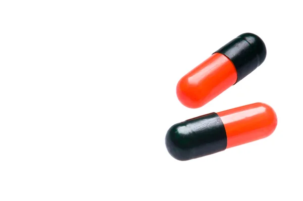Two Bicolor capsules over white — Stock Photo, Image