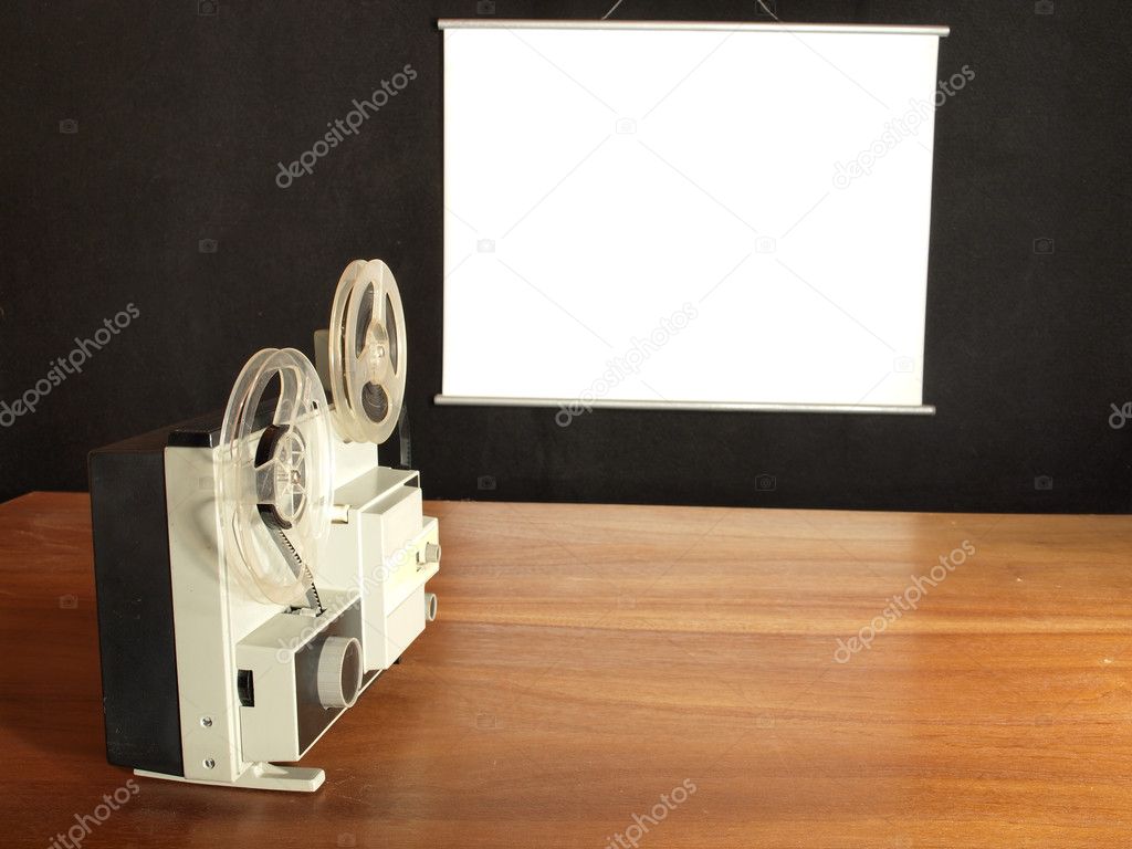 Film projector aimed at the screen hanging on the log wall