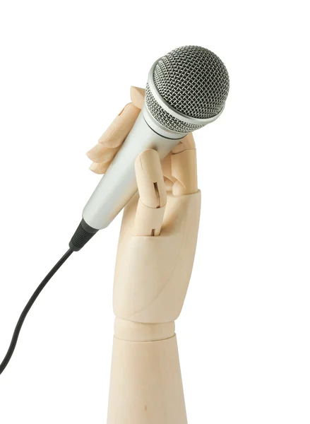 Holzhand hält ein Mikrofon — Stockfoto