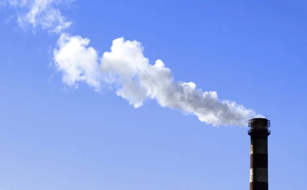 Stock image A stack and a smoke in the spring sky