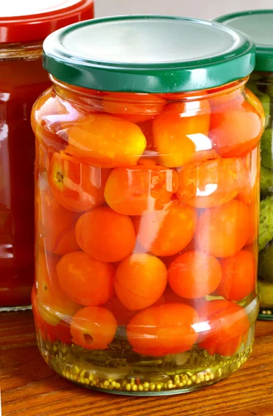 Canned tomatoes on the table — Stock Photo, Image