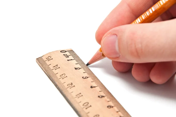 Mão desenha uma linha com um lápis e régua Imagem De Stock