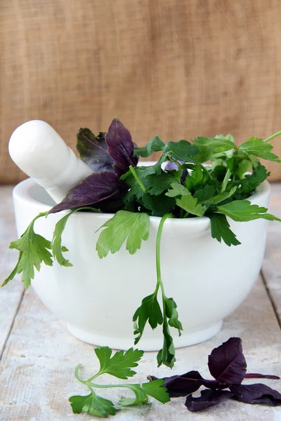 Mortar and pestle with herbs — Stock Photo, Image