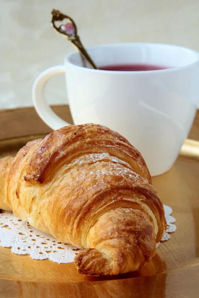 Croissant et une tasse de thé — Photo