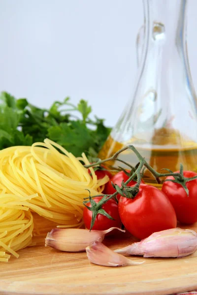 Italian pasta, olive oil and tomato — Stock Photo, Image