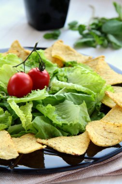 Mexican tortilla chips with lettuce leaves clipart