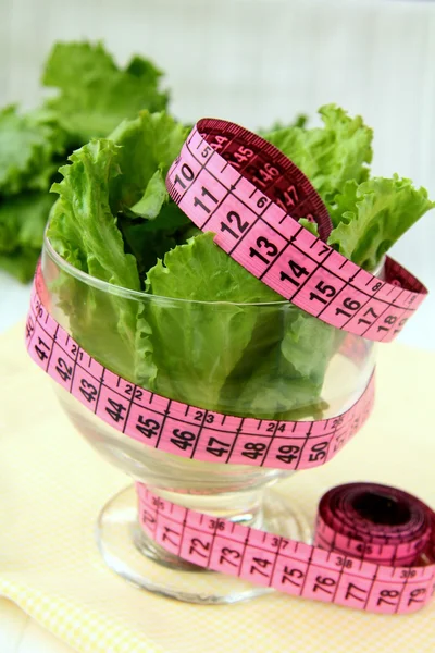 Green salad diet with a measuring tape — Stock Photo, Image
