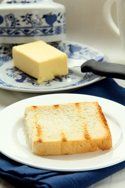 Fresh yellow butter on toast — Stock Photo, Image