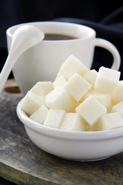 A cup of black coffee and refined sugar — Stock Photo, Image