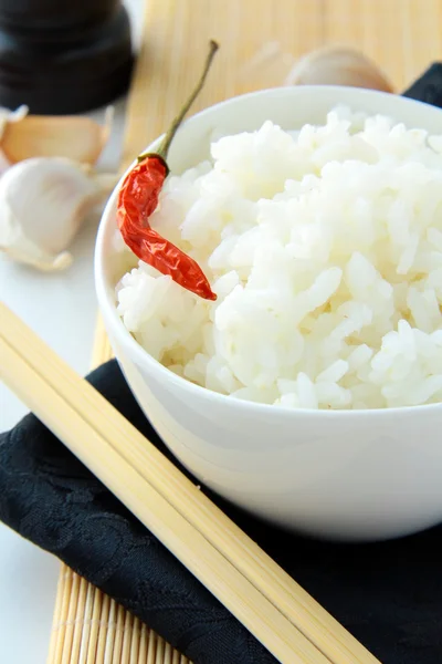 Bowl of white fluffy rice with chopsticks — Stock Photo, Image
