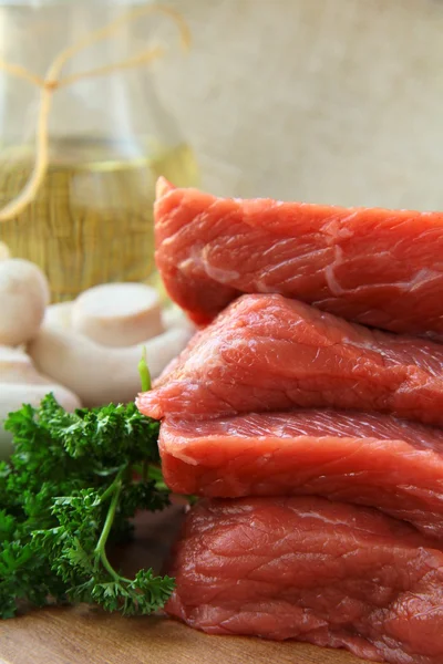 Fresh raw beef with mushrooms and parsley — Stock Photo, Image