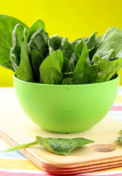 Fresh spinach in a green bowl — Stock Photo, Image