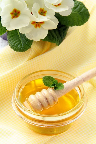 Färsk gyllene honung i burk med en träslev — Stockfoto