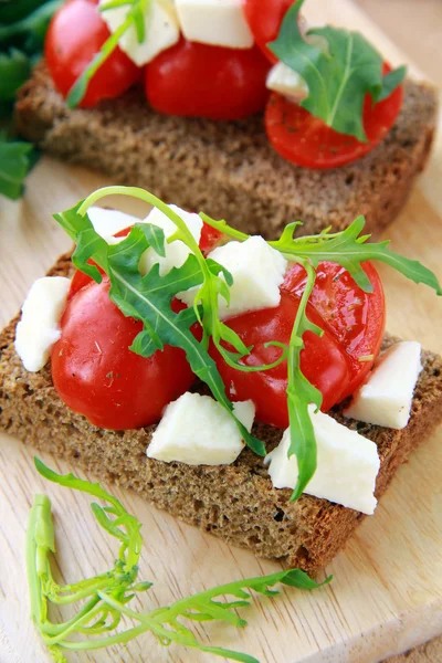 stock image Sandwich with mozzarella and tomatoes on rye bread