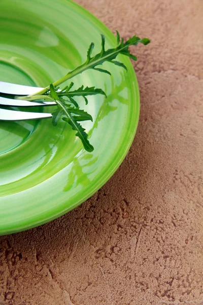 Зеленая тарелка с вилкой — стоковое фото