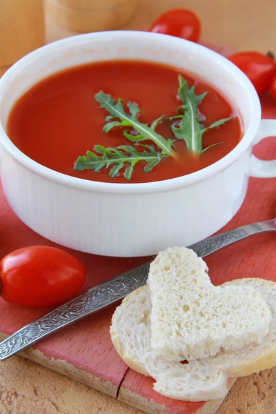 stock image Tomato soup in a white bowl with arugula