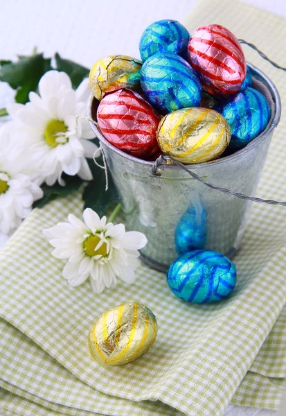 Bucket filled with chocolate eggs Easter sweets — Stock Photo, Image