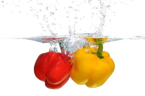 stock image Red and yellow Bell Pepper splashing