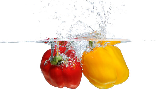 Red and yellow Bell Pepper splashing