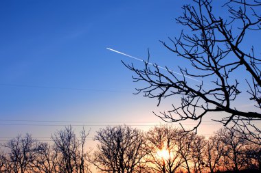 Track aircraft against a background of clear blue autumn sky clipart