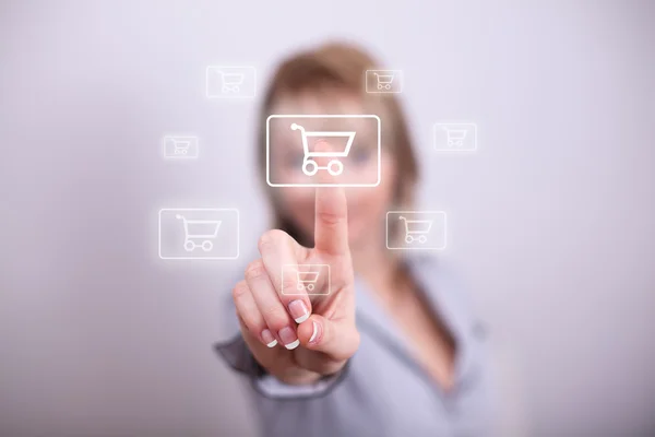 Woman pressing mdoern shopping button with one hand — Stock Photo, Image