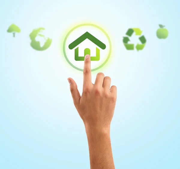 Mão pressionando símbolo de casa de ícones verdes eco — Fotografia de Stock