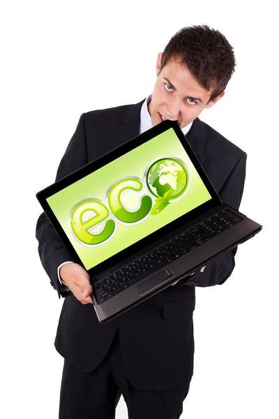 A businessman bites a laptop with eco sign — Stock Photo, Image