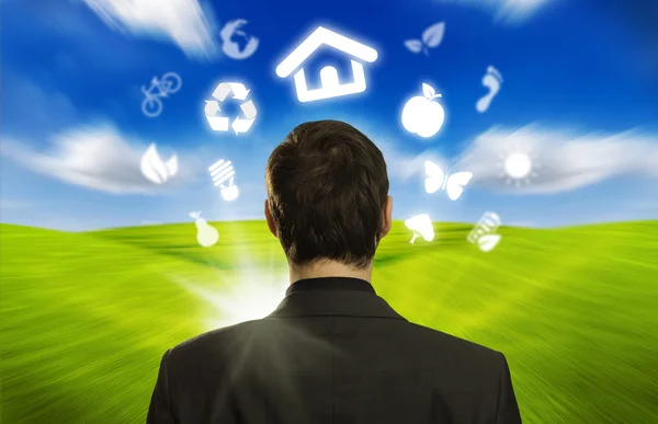 stock image Businessman with ECO icons floating around his head