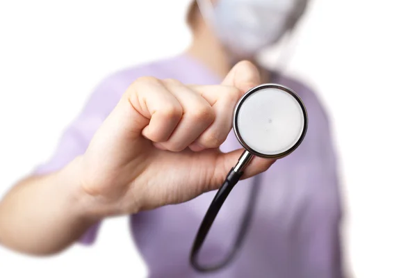 Female doctor holding stethoscope pointed toward camera — Stock Photo, Image