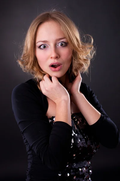 Emotional girl on a black background — Stock Photo, Image