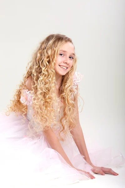 Beautiful little girl in dress with long hair on grey background — Stock Photo, Image