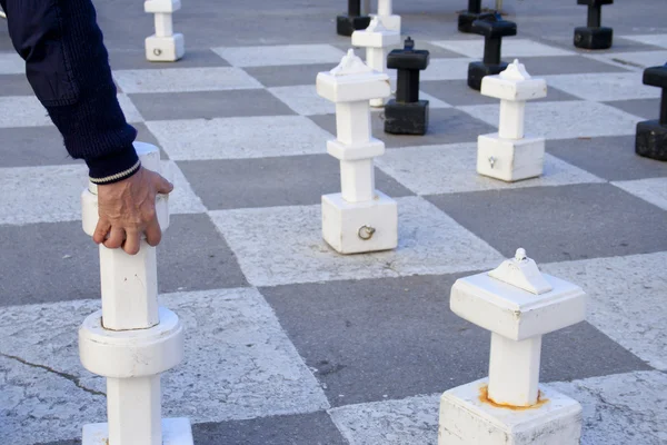 stock image A man playing giant white chess outdoors