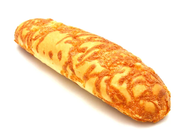 The ruddy long loaf of bread is strewed by cheese — Stock Photo, Image