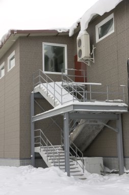 Ladder in snow on the second floor with windows clipart