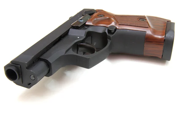 O fim de uma pistola um alvo e cartuchos isola-se em — Fotografia de Stock