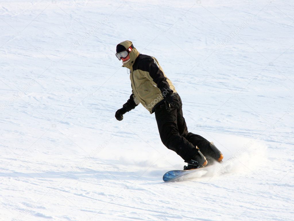 Snowboarder in a yellow suit going from mountain on against wood