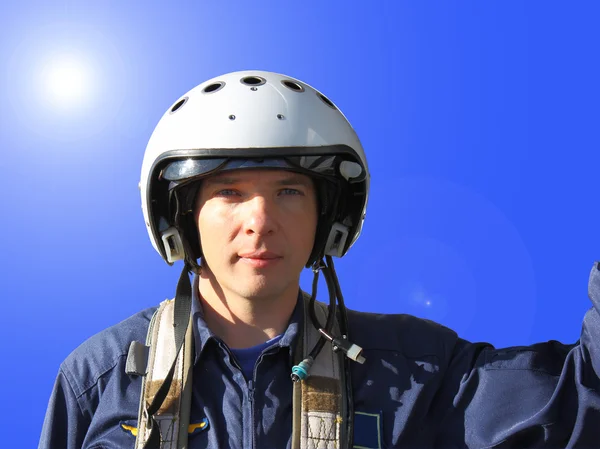 stock image The military pilot in a helmet in dark blue overalls separately