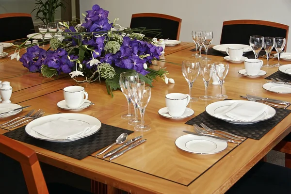 stock image Restaurant table setup with cut flowers