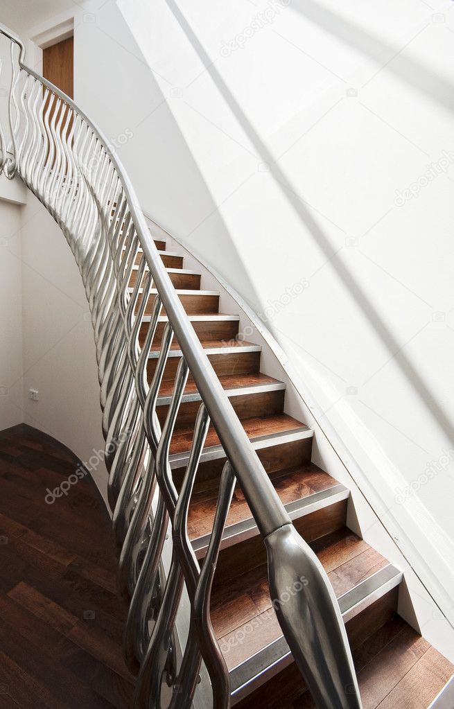 Modern designer staircase with interesting matt finish metal hand rail