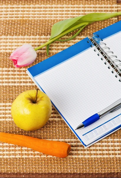 Open notebook, yellow apple and pencil — Stock Photo, Image
