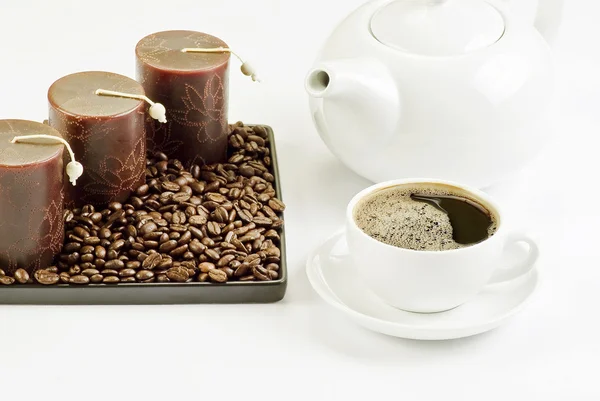 stock image Cup of coffee with coffee beans and candles