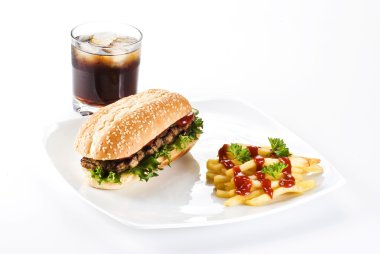 Ribeye steak in sesame seed bun with fries and coke clipart