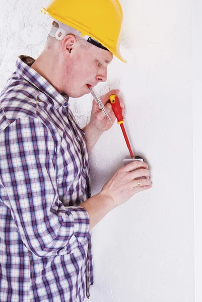 stock image Young Electrician fitting new light switch