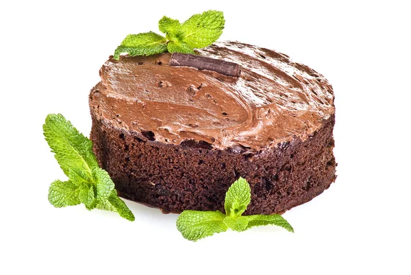 stock image Dark brown chocolate cake and mint leaves over white background