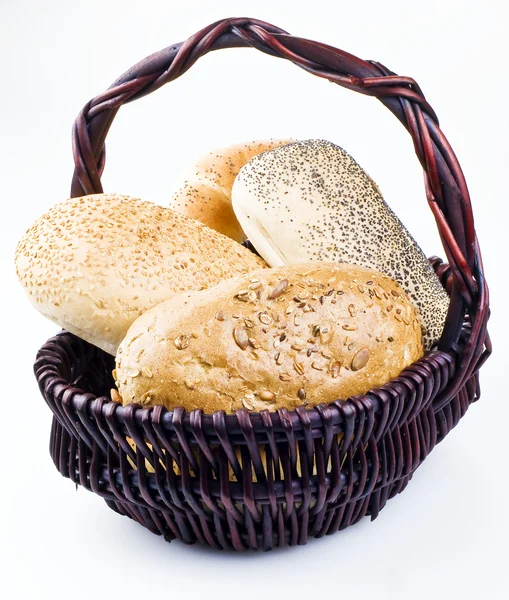 Stock image Several different kind of rolls in basket isolated over white