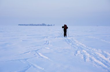 Cross-country skier in deep tracks clipart